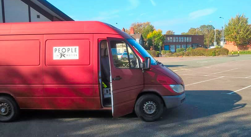Transit van with 'People in Motion' logo on the side